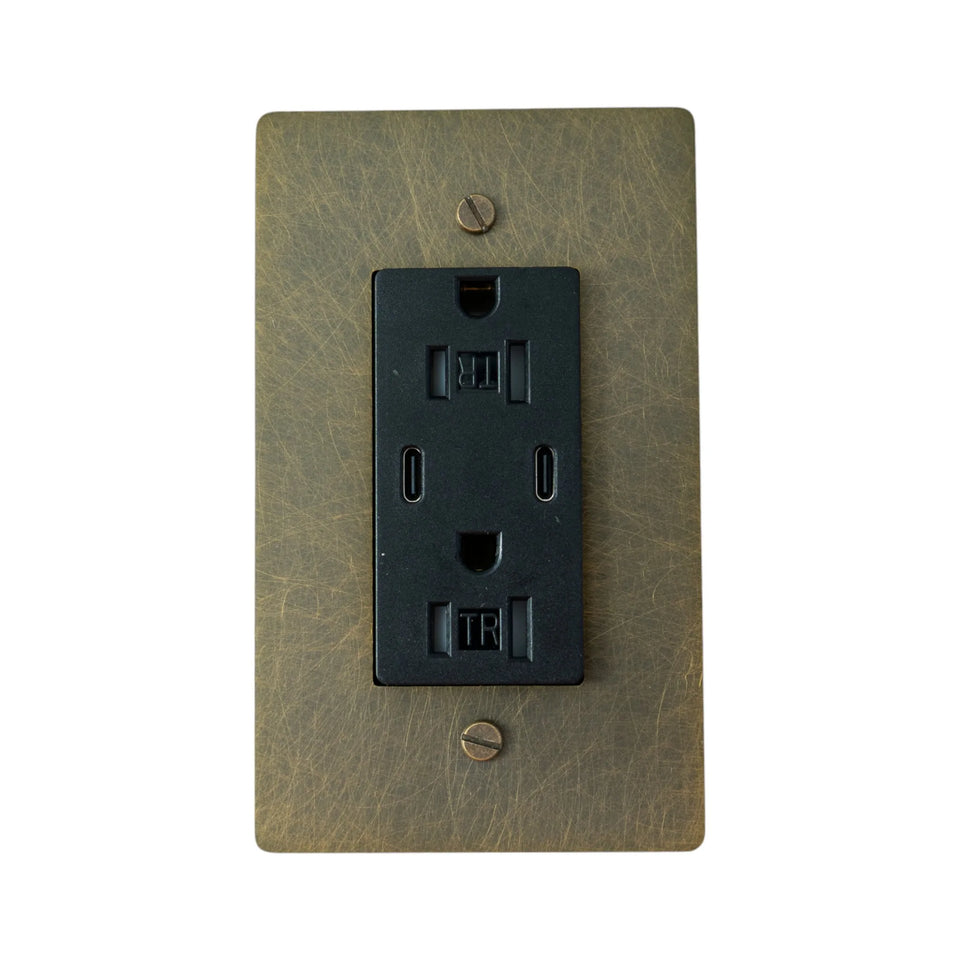 Dual USB-C outlet with brushed bronze wall plate.