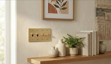 beautiful interior design with light beige wall, ceramic vases and satin brass light switch plate with two toggles and two dimmers for the right finish.