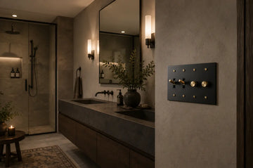 Modern bathroom designed with brass elements, brass taps and brass black light switch with 2 dimmers and 2 toggles in gold finish.