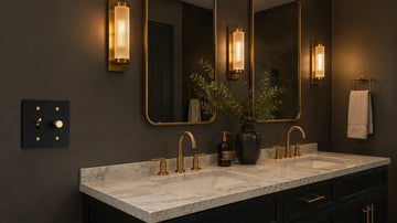 beautiful set of single pole black matte dimmer switches installed on a dark green wall in a luxury bathroom