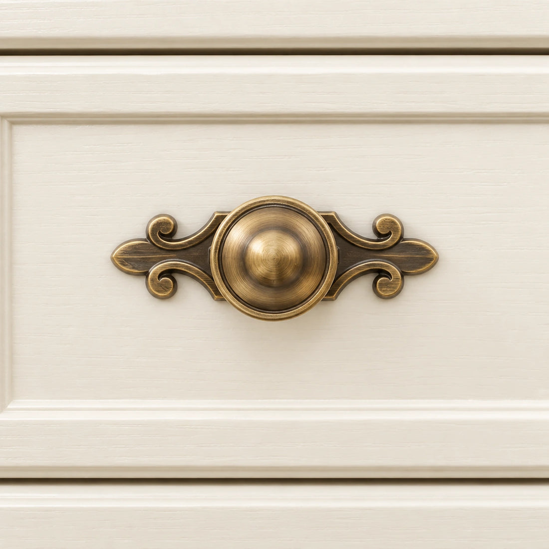 Antique brass domed cabinet knobs with and without ornate backplate on limestone
