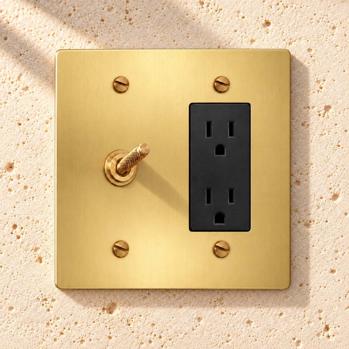 2-Gang Solid Brass Knurled Toggle Light Switch & Duplex Outlet in Satin Brass; 1 toggle + 1 duplex outlet on a white background