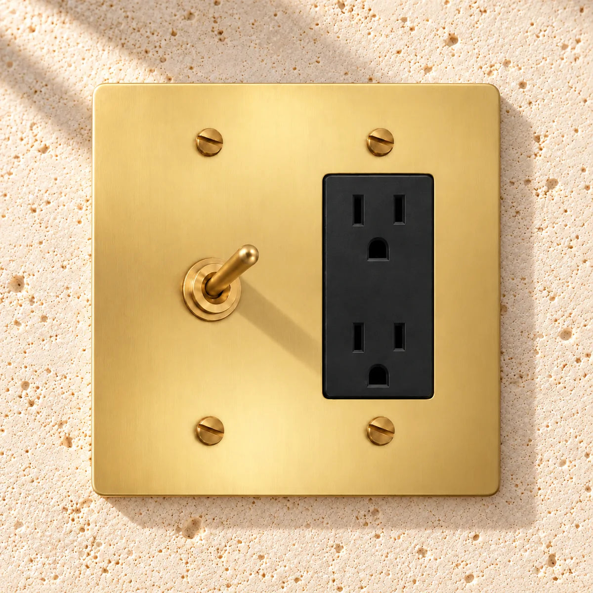 2-Gang Solid Brass Toggle Light Switch & Duplex Outlet in Satin Brass; 1 toggle + 1 duplex outlet on a white background
