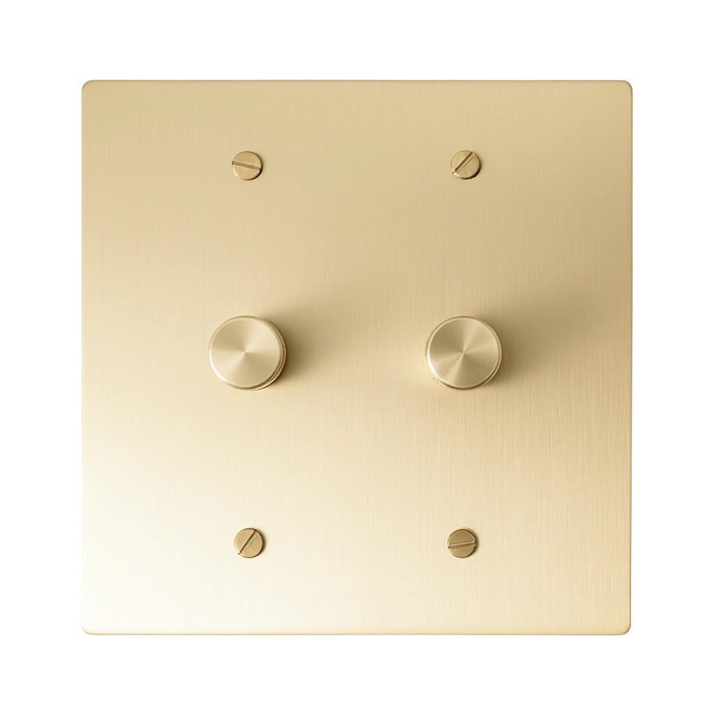 Two gang brushed brass dimmer switch plate with dual rotary knobs for elegant lighting control.
