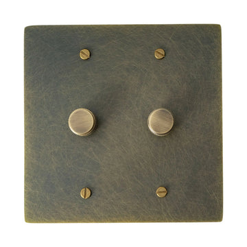 2 gang Bronze brass dimmer switch plate with antique knob on a white background