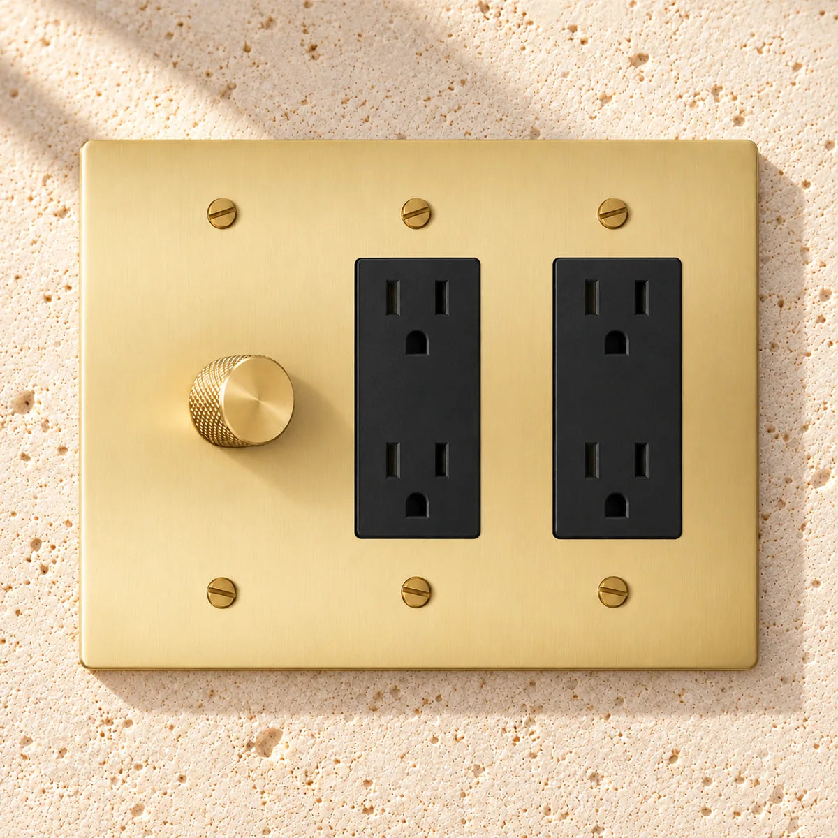 3-Gang Solid Brass 1 Rotary Dimmer + 2 Duplex Outlets on sunlit pale limestone