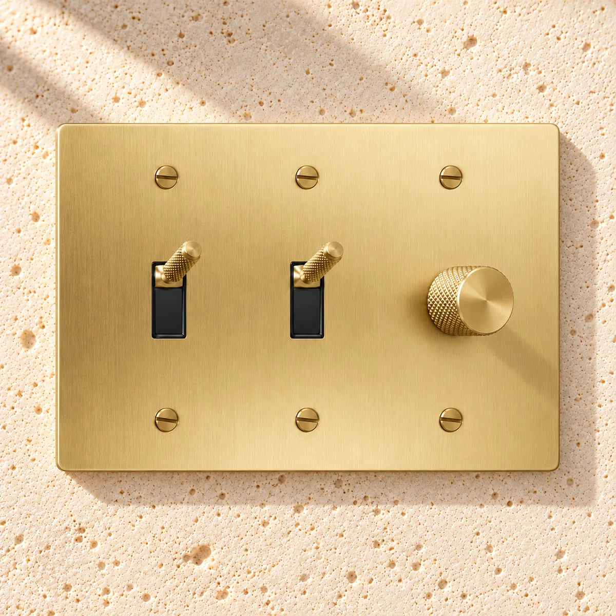 3-Gang Knurled Brass Toggle Light Switches & Rotary Dimmer in Satin Brass; 2 toggles + 1 rotary dimmer on a white background