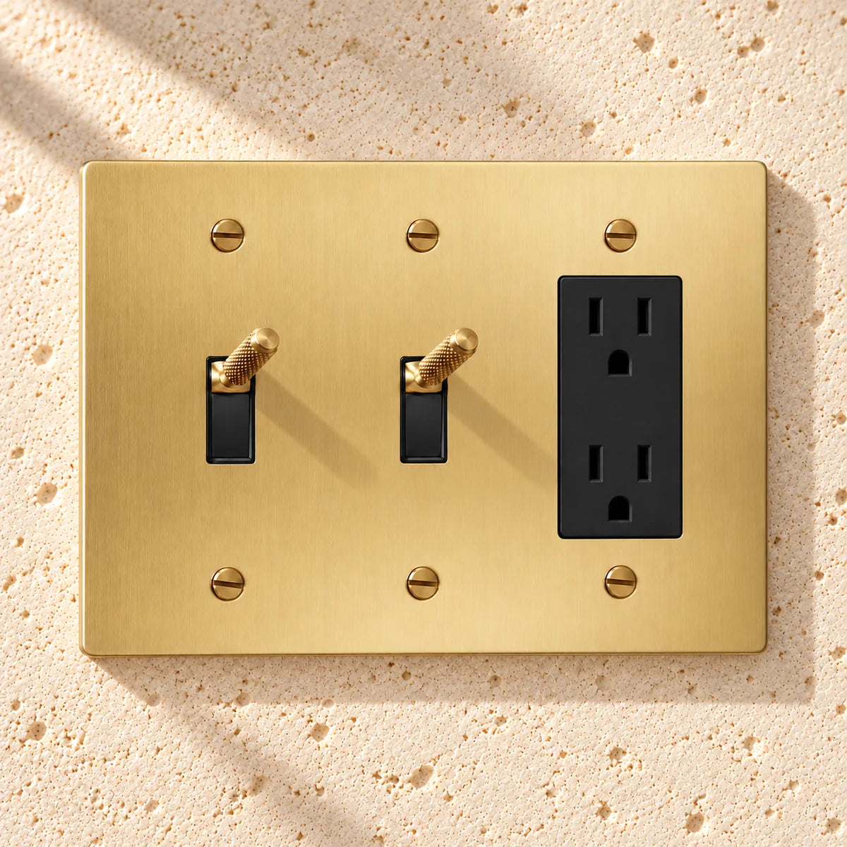 3-Gang Knurled Brass Toggle Light Switches & Duplex Outlet in Satin Brass; 2 toggles + 1 duplex outlet on a white background