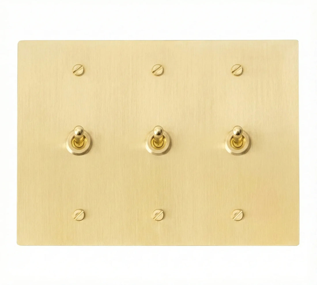 3-gang solid brass retro toggle light switch in satin brass finish, front view.