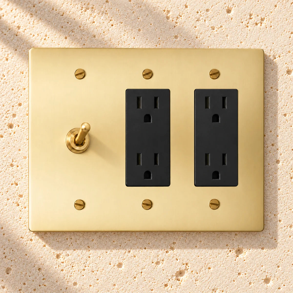 3-Gang Solid Brass Toggle Light Switch & 2 Duplex Outlets in Satin Brass; 1 toggle + 2 duplex outlets on a white background