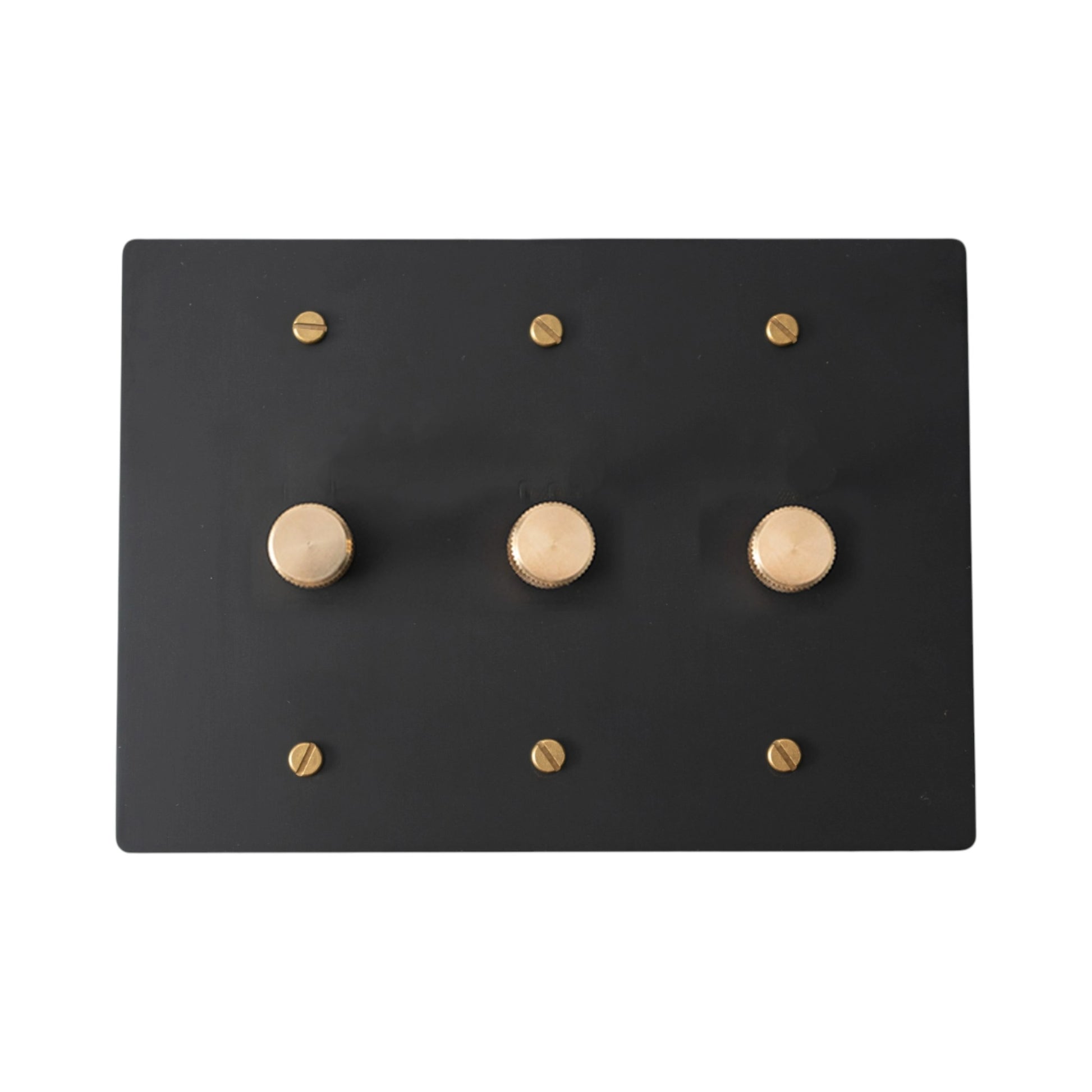 Black 3 gang dimmer wall plate with gold screws on a white background