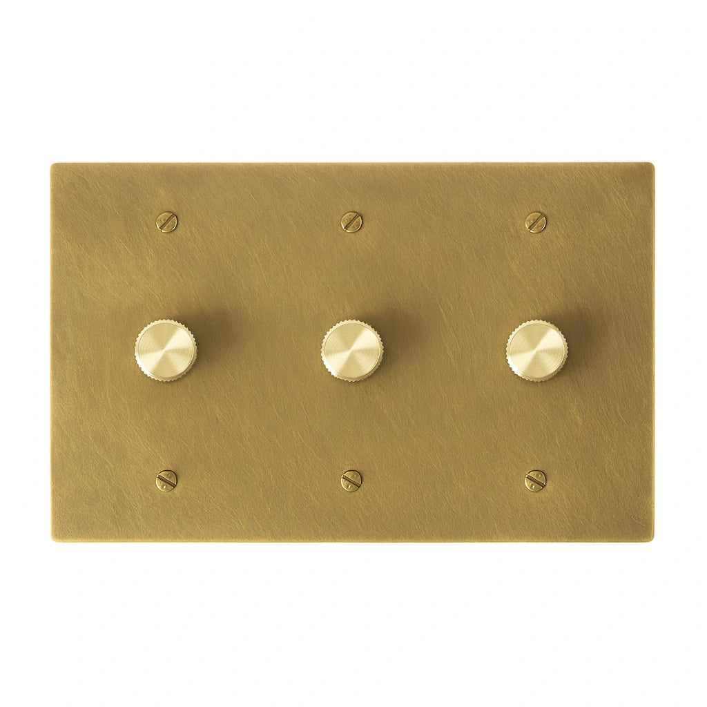 Three gang antique brushed brass dimmer switch with smooth brass control knobs and vintage finish.