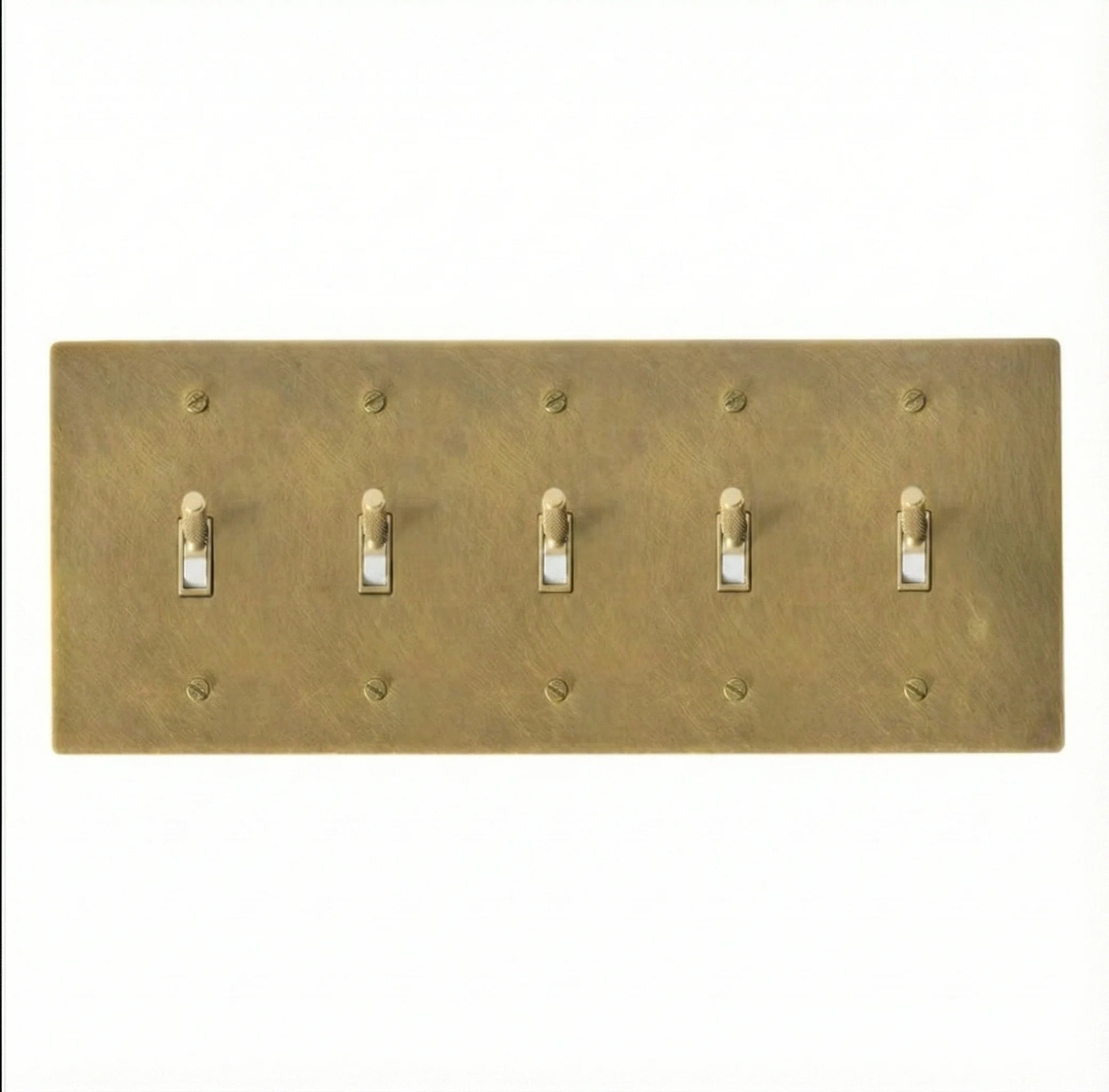 Close-up of knurled toggles on unlacquered antique brass 5-gang switch plate