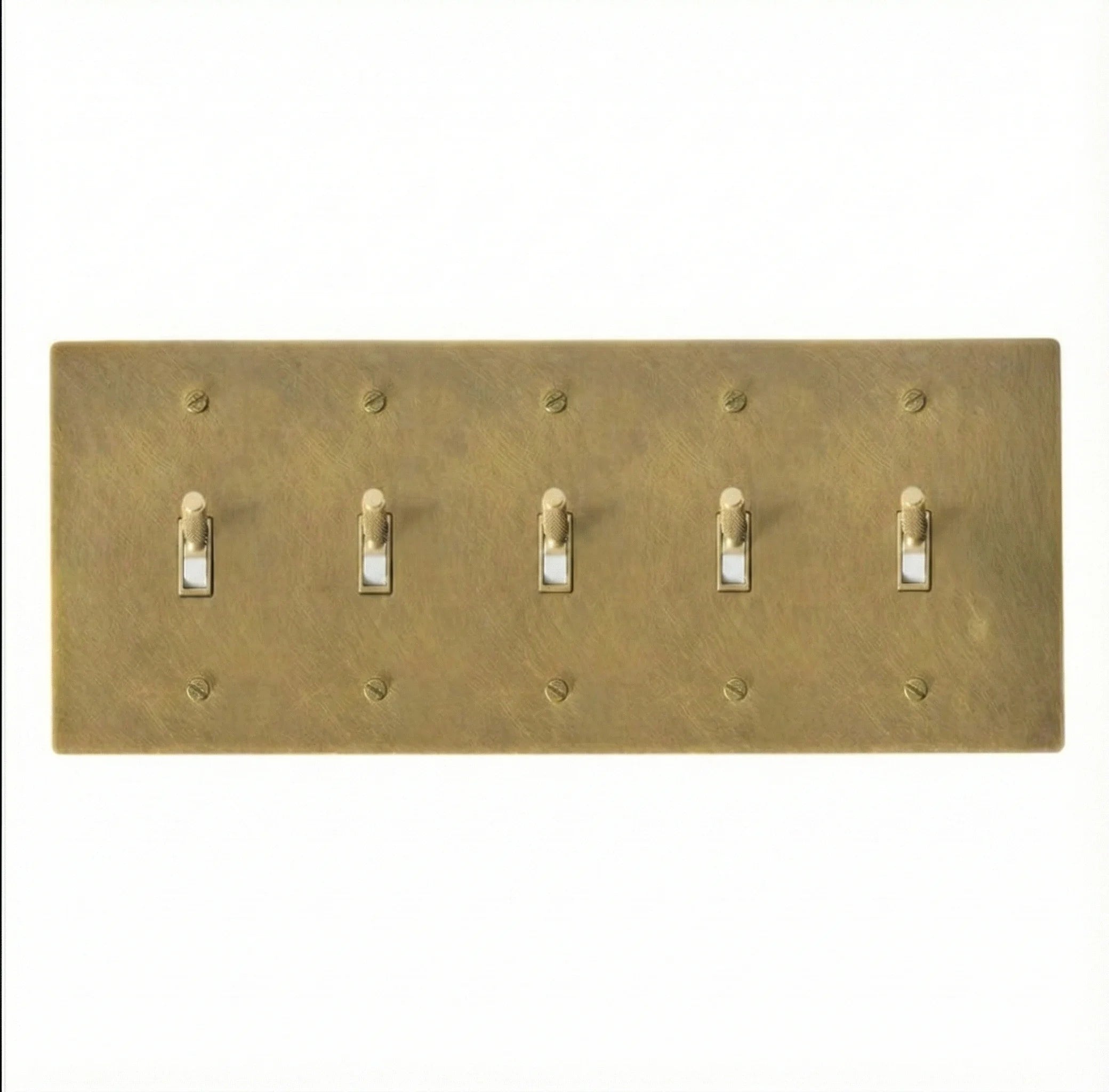Close-up of knurled toggles on unlacquered antique brass 5-gang switch plate