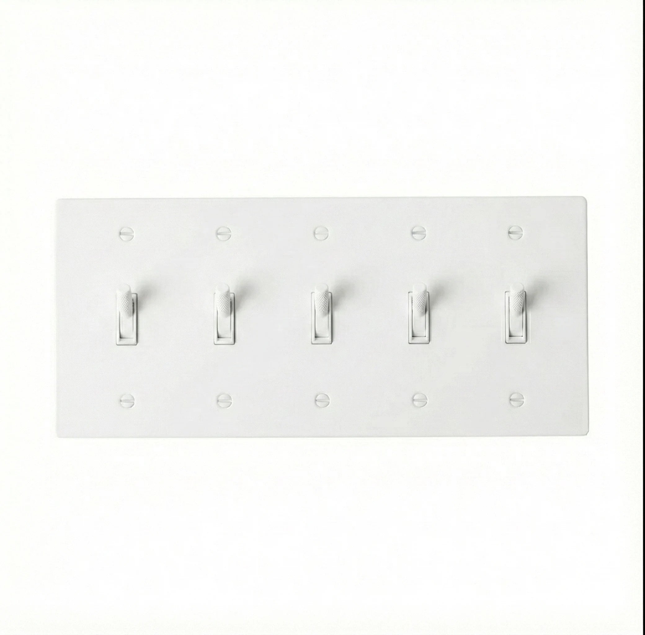 Close-up of knurled toggle detail on white 5-gang switch plate