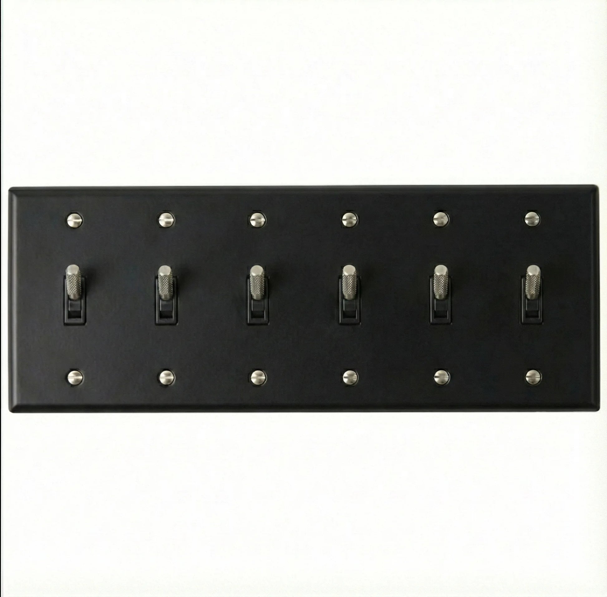 Back view of 6-gang toggle switch plate, matte black finish, mounting hardware visible