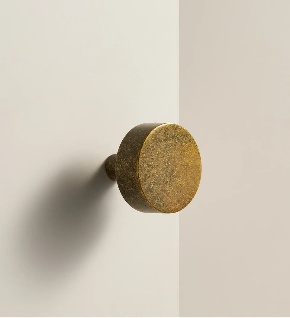 Antique brass ice flower vintage door knob on a beige background.