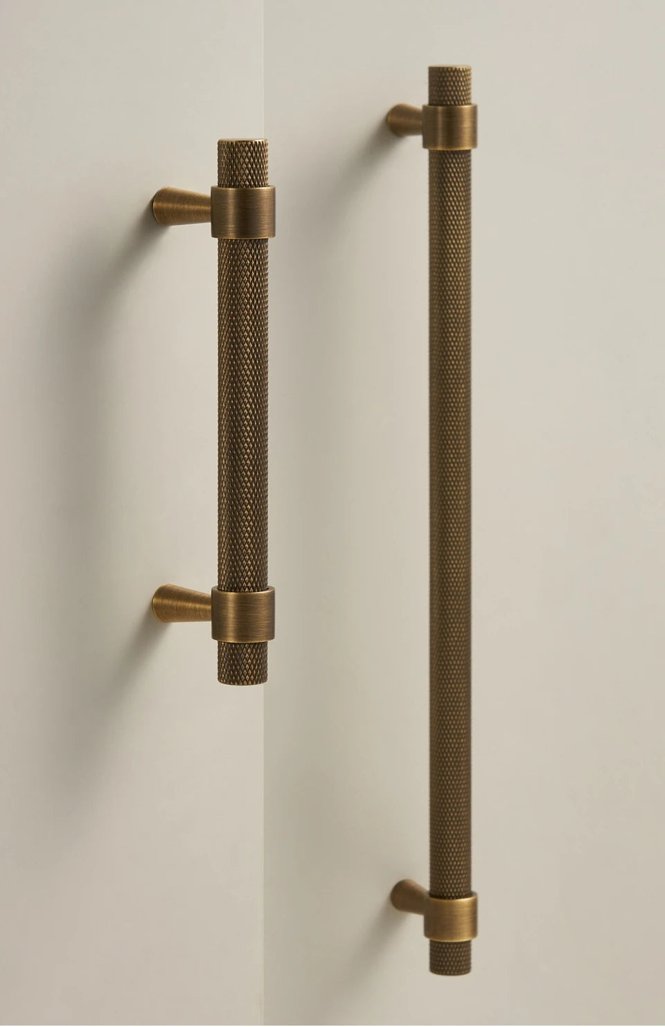 Bronze textured door handles on a white door.