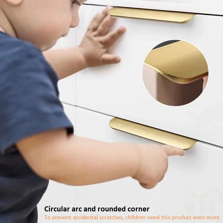 Child interacting with a white cabinet featuring gold invisible aluminum edge pulls, emphasizing safety features.