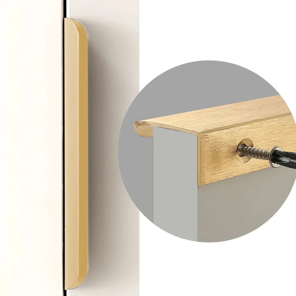 Close-up of a gold door hidden edge pull on a white door with a grey circle highlighting the handle.