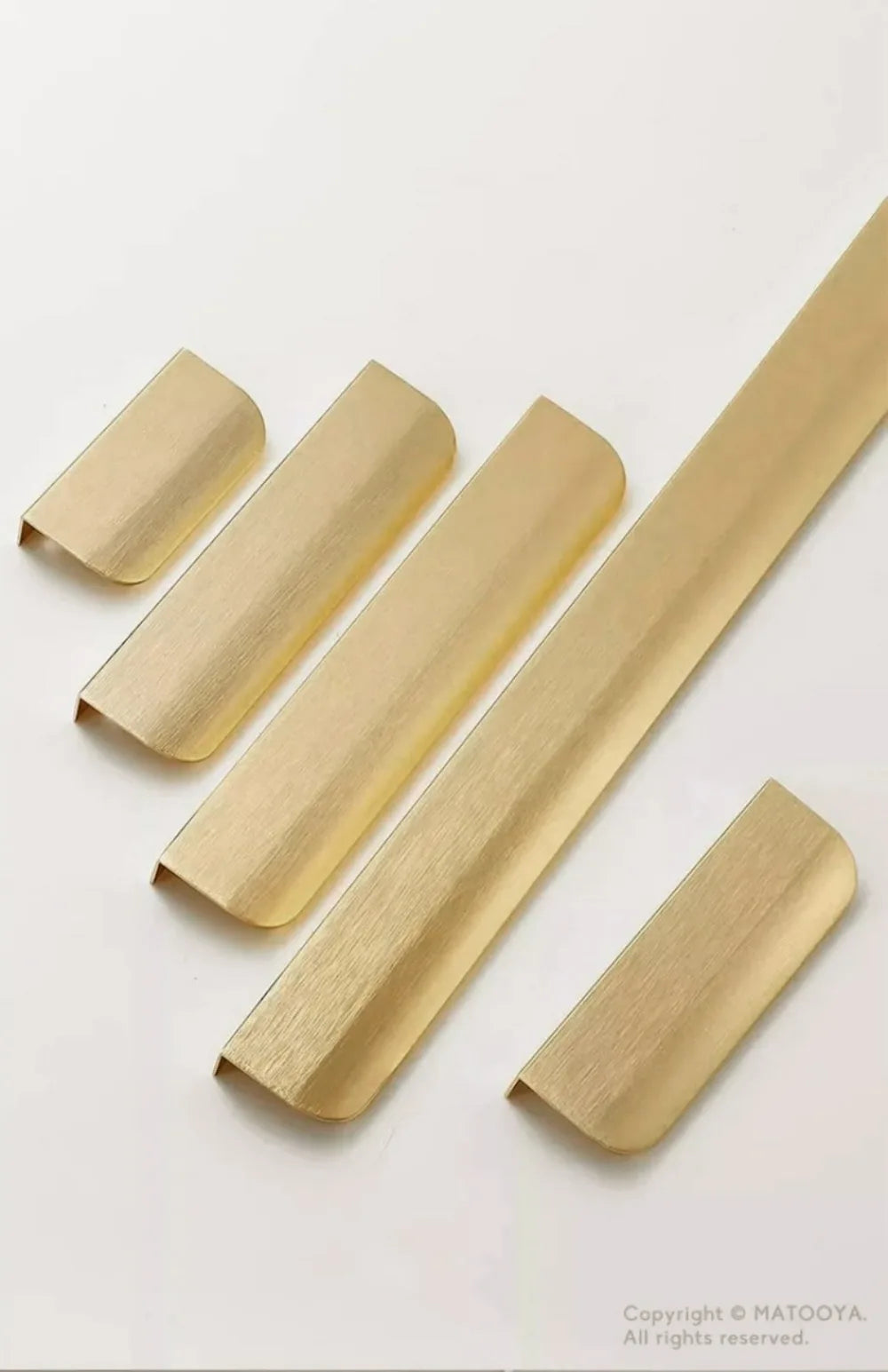Five gold aluminium edge pulls on a white background.