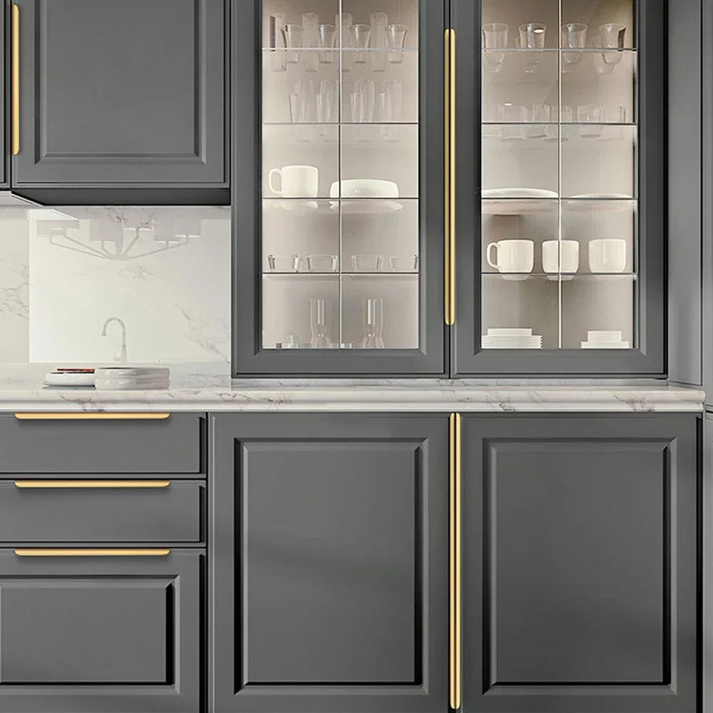 Person using a kitchen cabinet edge pull with a sink and countertop in the background.