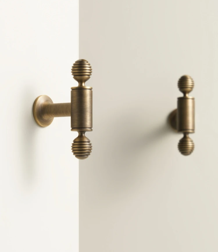 Pair of vintage-style solid brass antique cabinet t-bars on a white background.