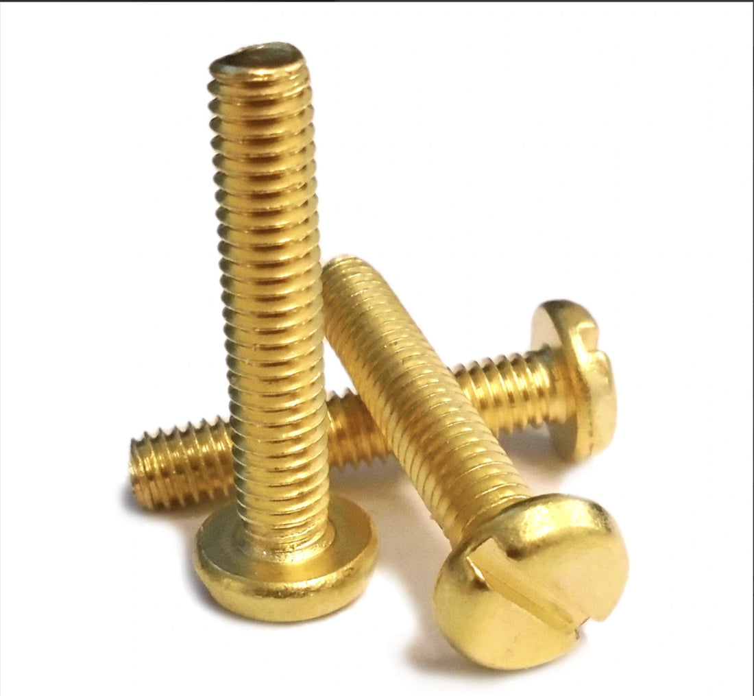 Three gold screws on a white background