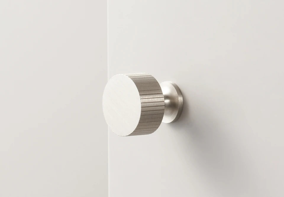 Art deco vertical line door knob on a white background.