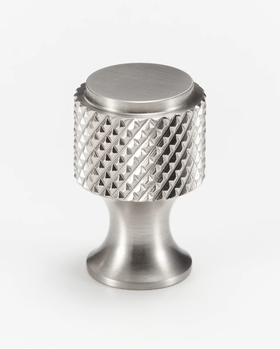 Single nickel cabinet knob knurled on a white background.