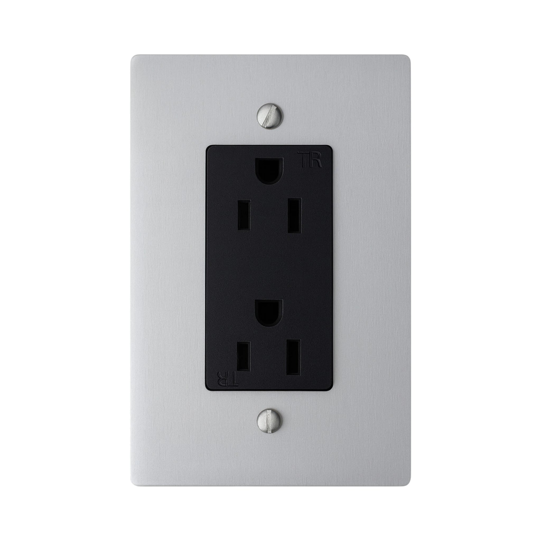 Black electrical outlet on a silver wall plate with screws