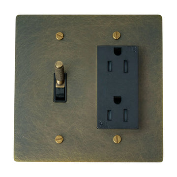 Antique bronze wall plate with toggle switch and outlet on a white background