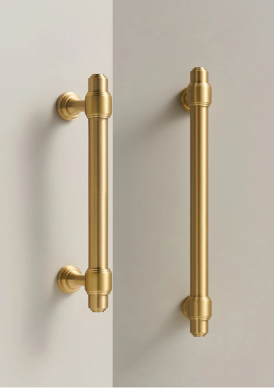 Two solid brass European luxury design gold handles on a white background.