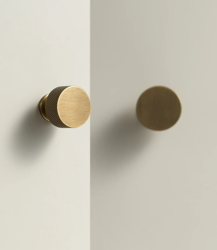 Pair of antique brass door handles on a white background