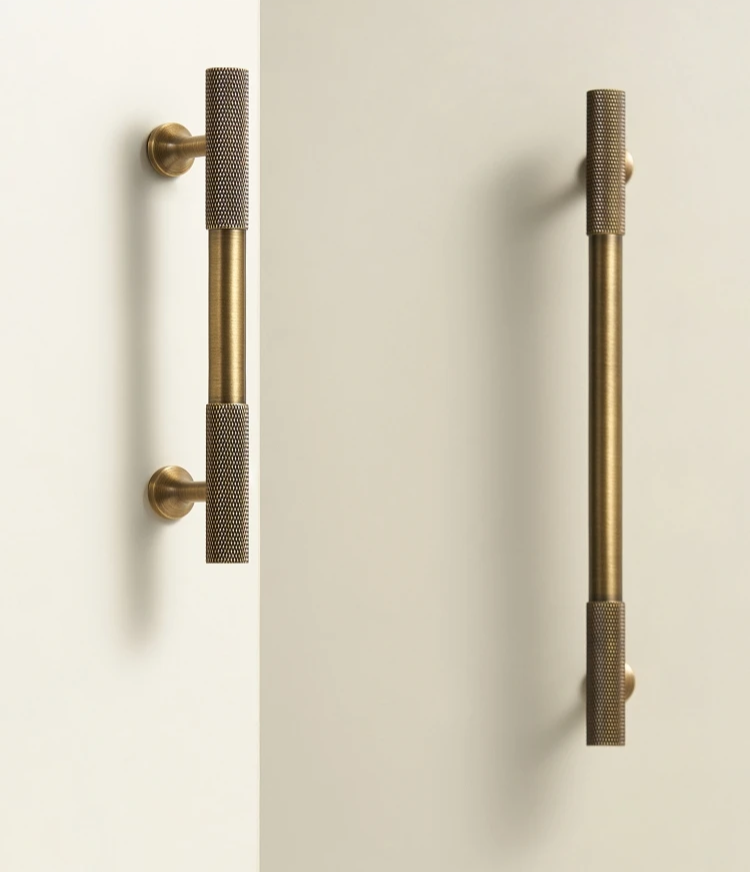 Pair of antique brass door handles on a white background