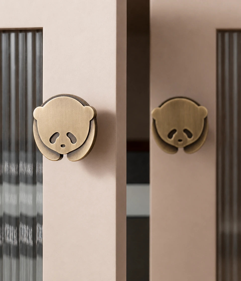 Resting panda brass knobs installed on fluted-glass cabinet doors