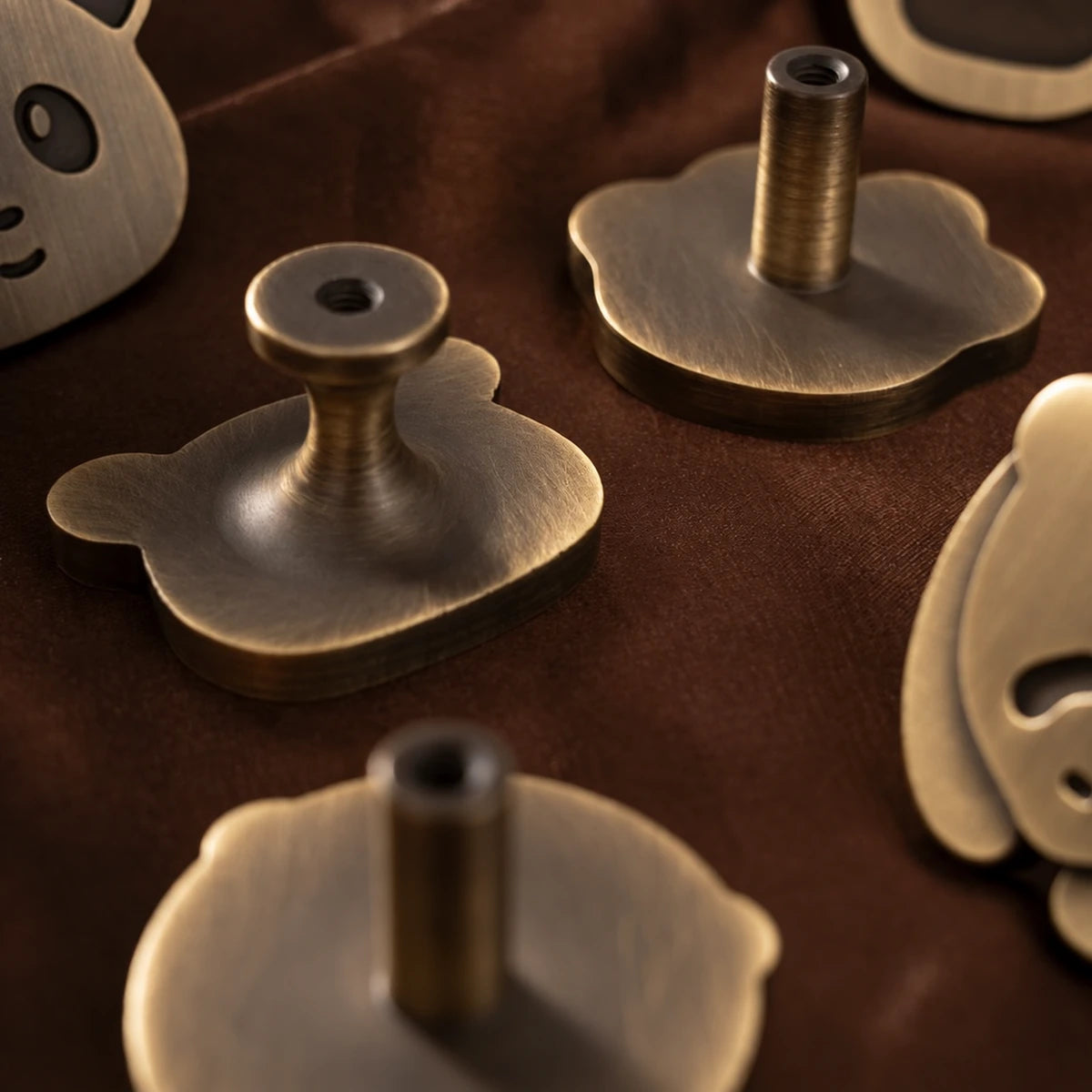 Rear mounting stems and screw holes of antique brass animal cabinet knobs