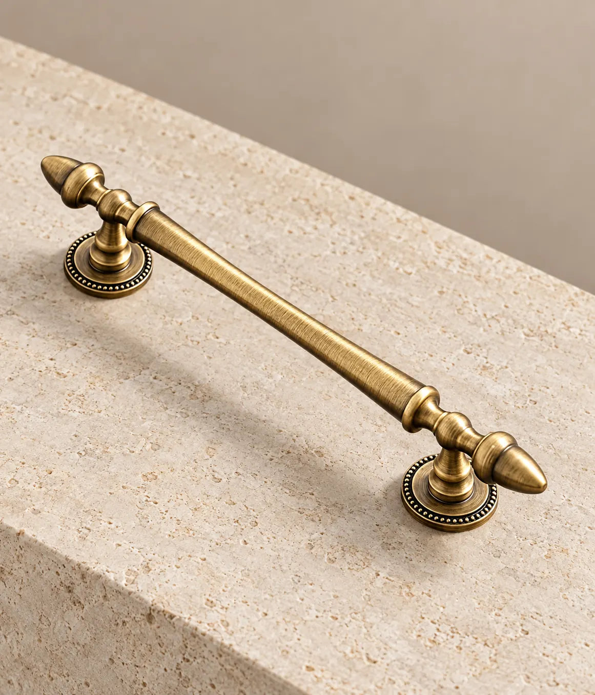 Detail of the acorn finial and beaded mounting base on an antique brass cabinet pull