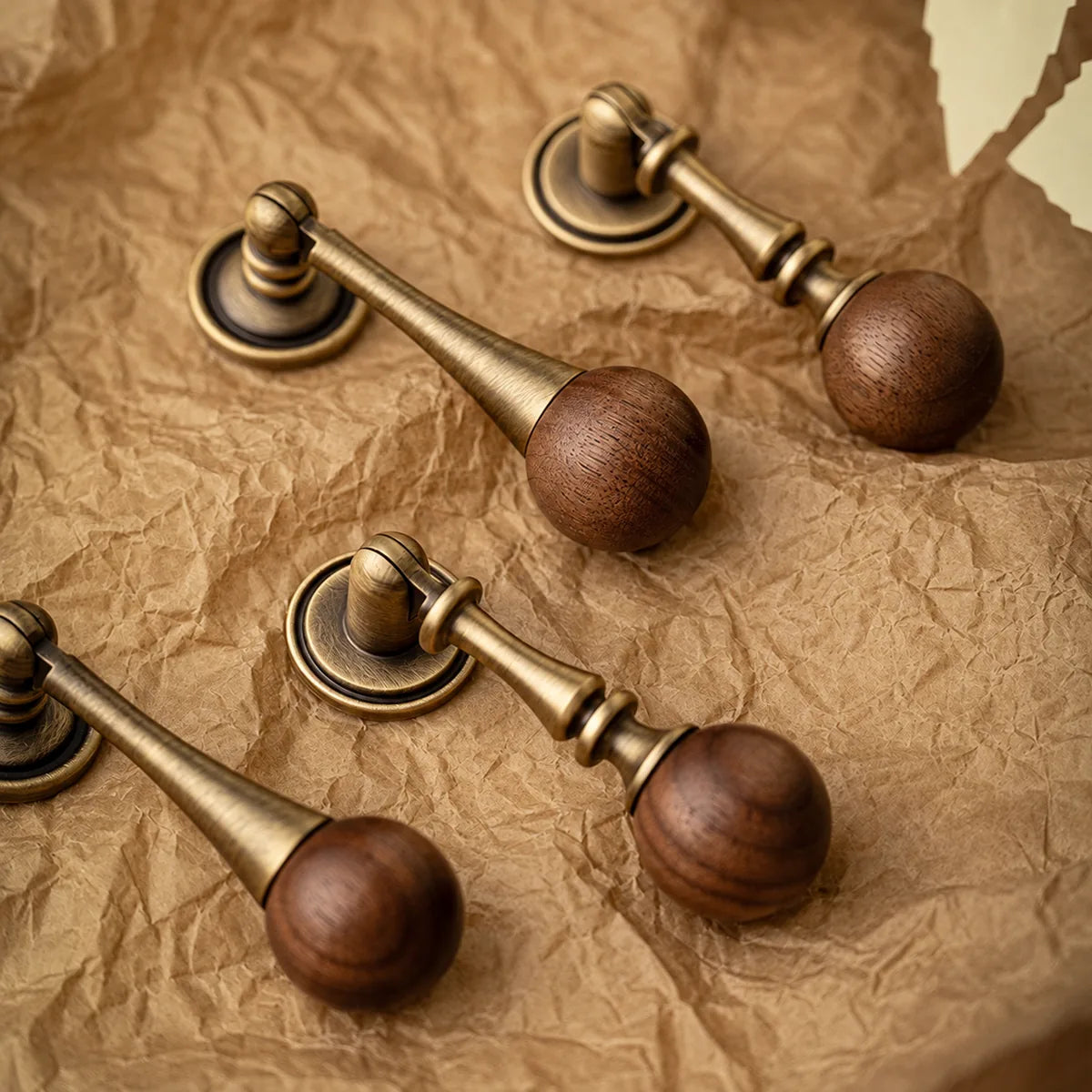 Tapered and turned antique brass drop stems with walnut ball grips