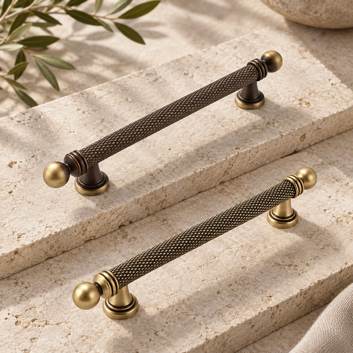 Dark and golden antique brass ball-end knurled cabinet pulls on limestone