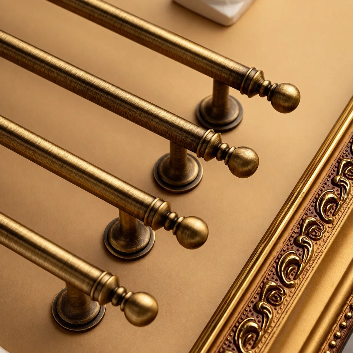 Close-up of antique brushed brass ball finials and decorative collars