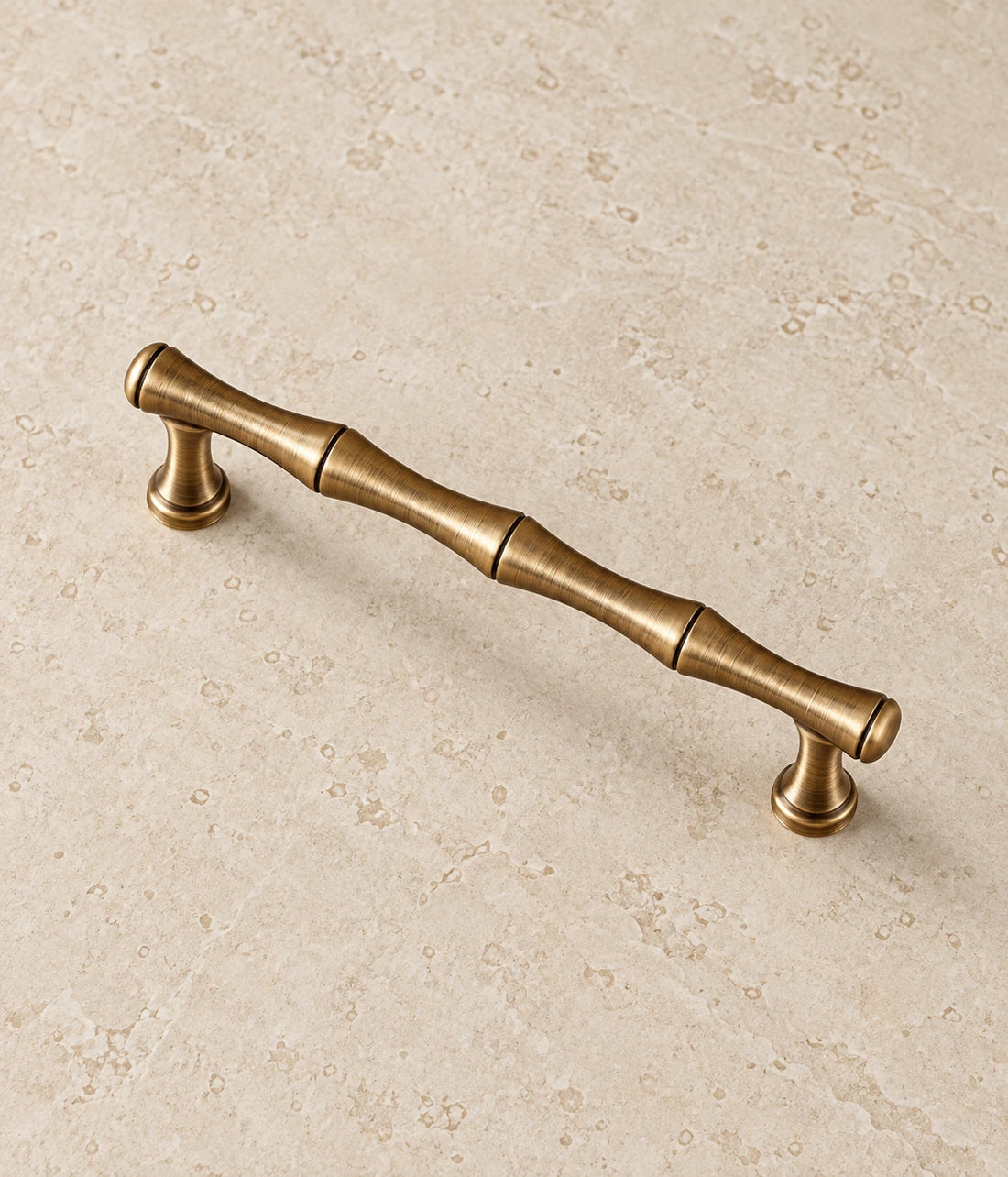 Antique Brass Bamboo Cabinet Pulls & T-Knob on warm ivory limestone