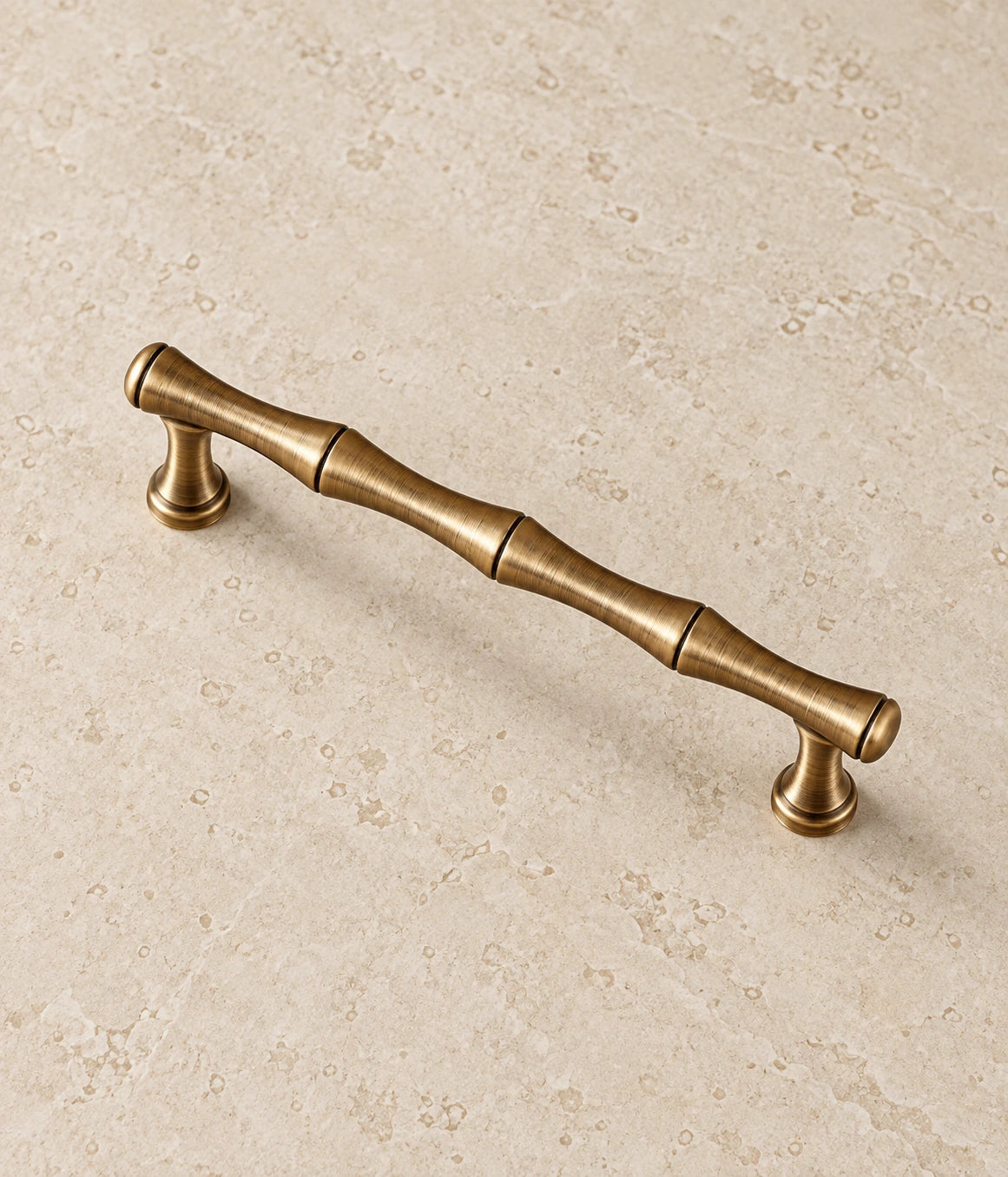 Antique Brass Bamboo Cabinet Pulls & T-Knob on warm ivory limestone