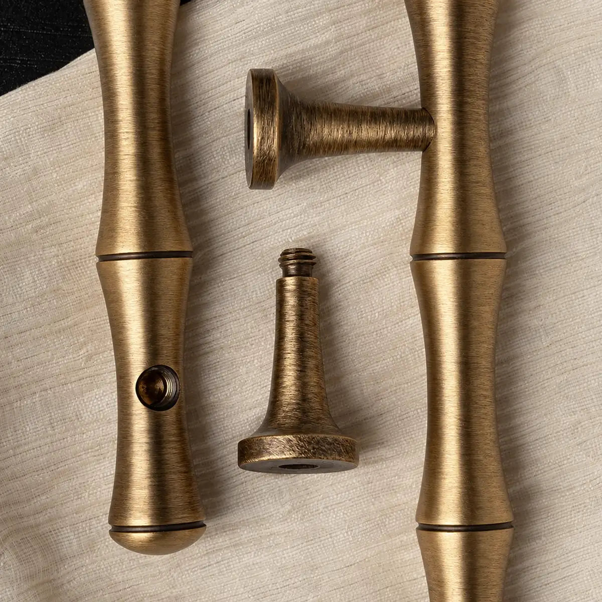 Bamboo cabinet pull mounting detail showing a detached threaded post and threaded opening