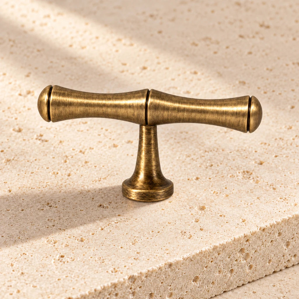 antique brass bamboo t knob limestone on pale limestone.