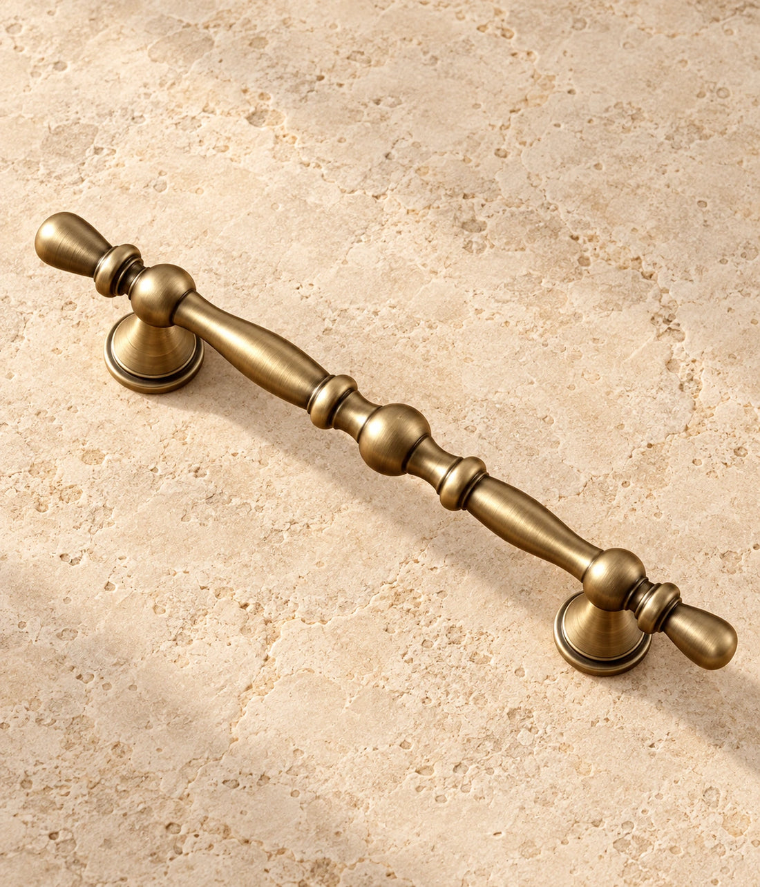 Antique Brass Beaded Cabinet Pulls on warm ivory limestone