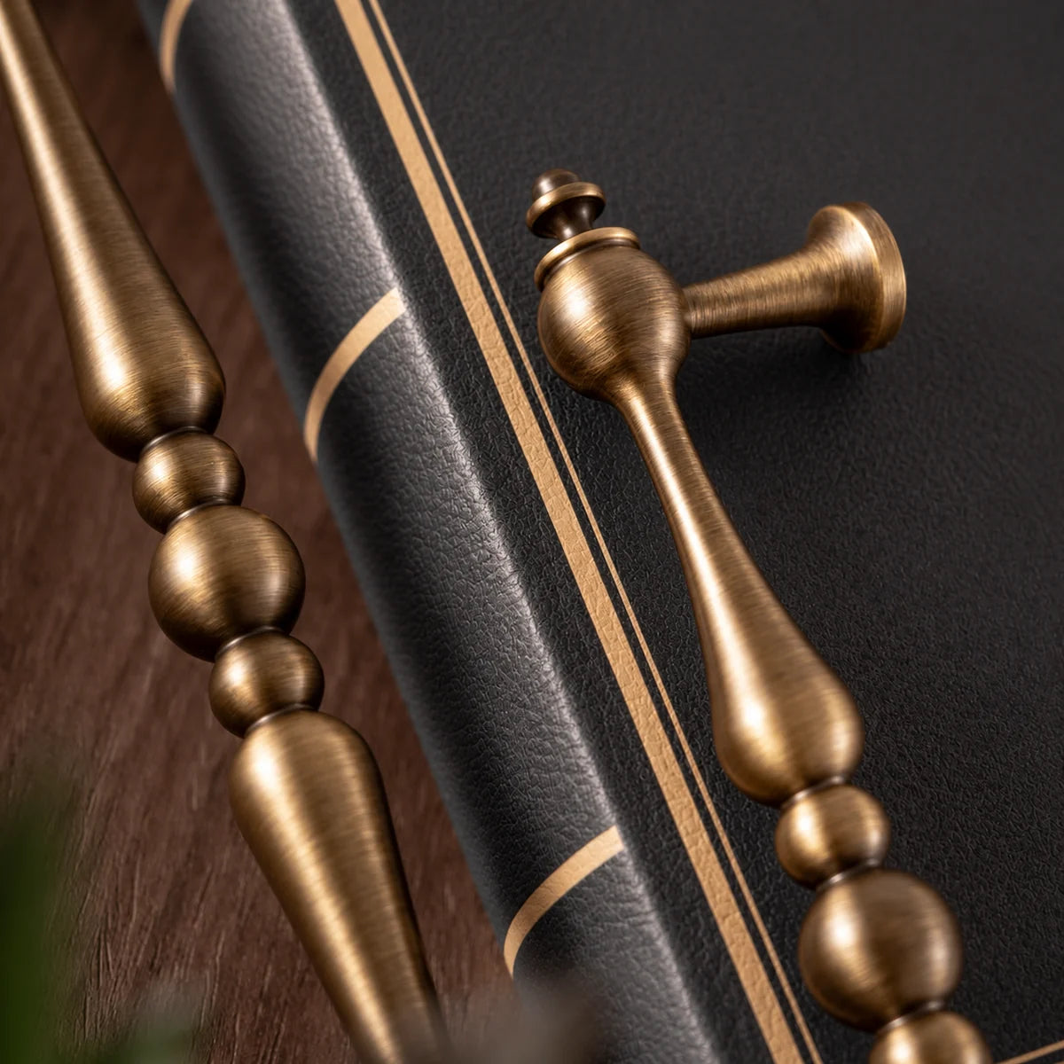 Detail of tapered brass grips, three central beads and a flared mounting post