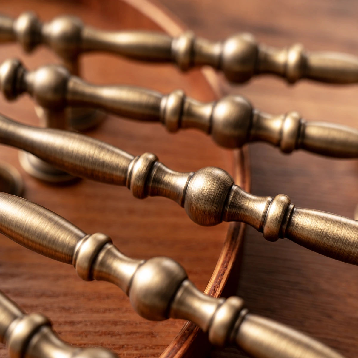 Close-up of rounded center beads and ring accents on antique brass cabinet pulls