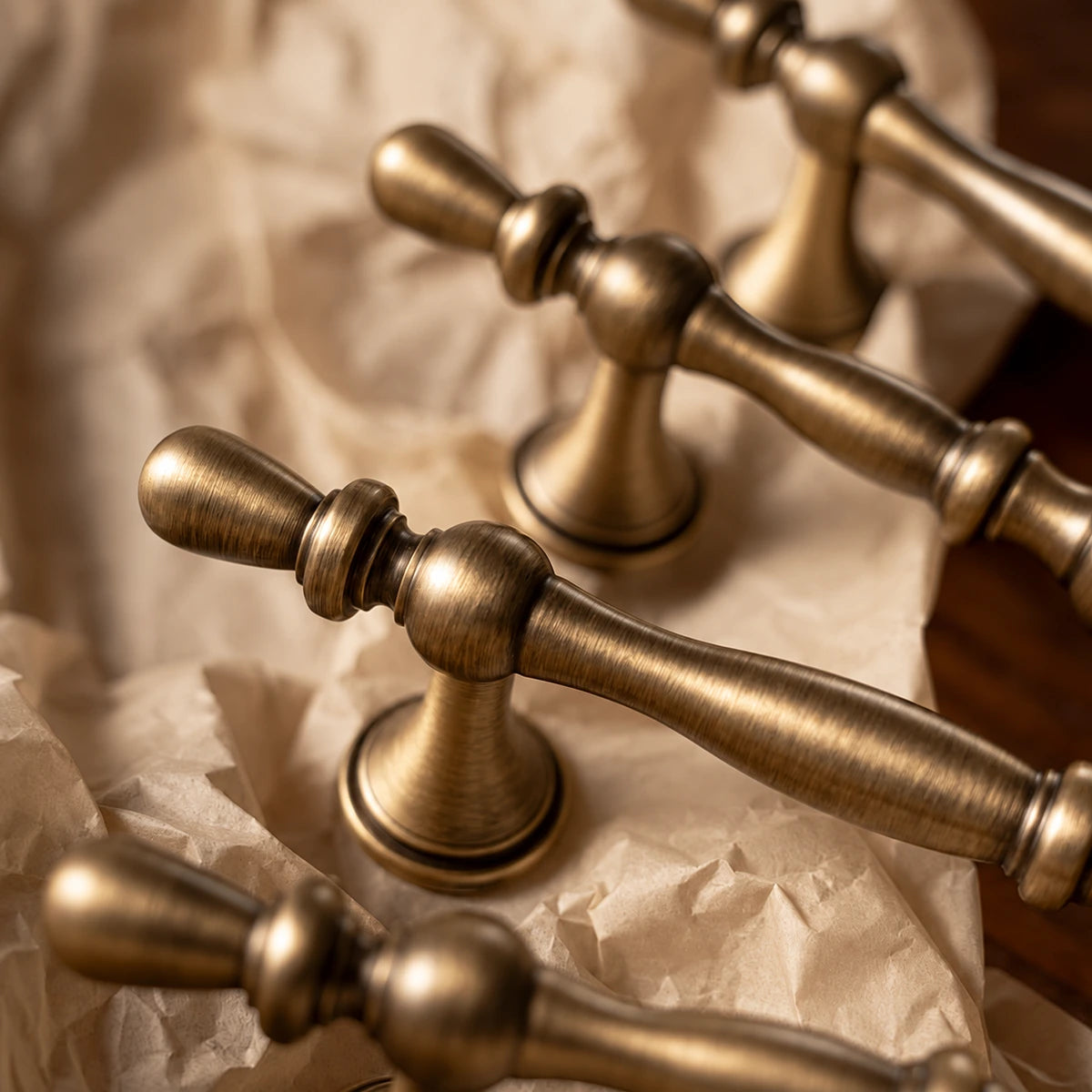 Close-up of antique brass beaded pull finials and flared mounting posts