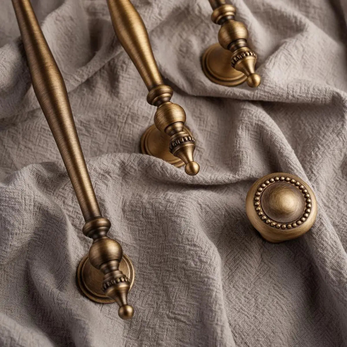 Antique brass spindle pulls and beaded knob on textured fabric